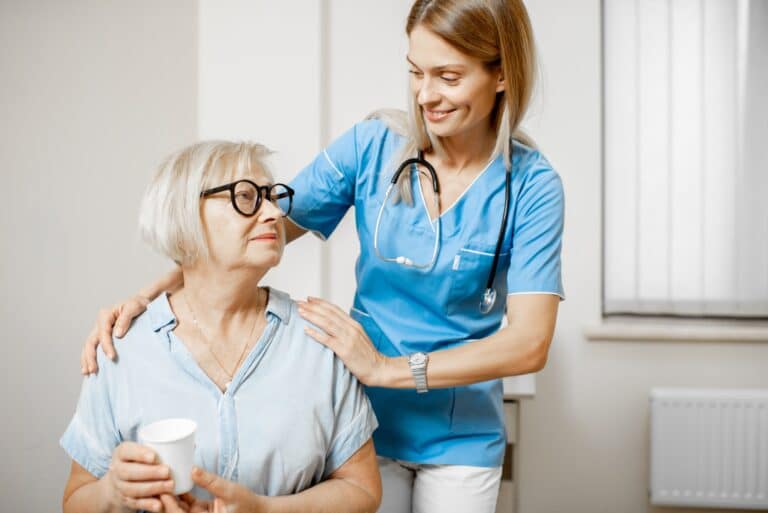Nurse taking care of senior woman